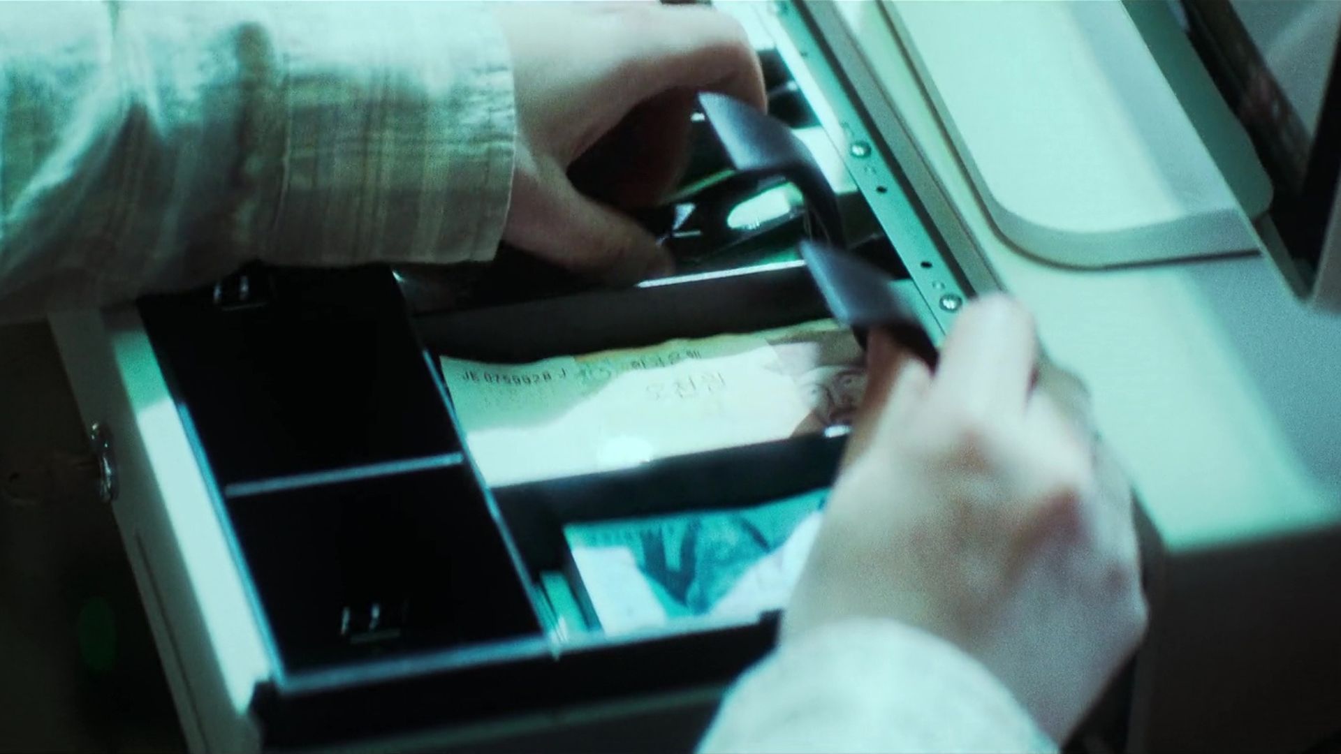 Film still from The 15th Hour showing a transaction moment