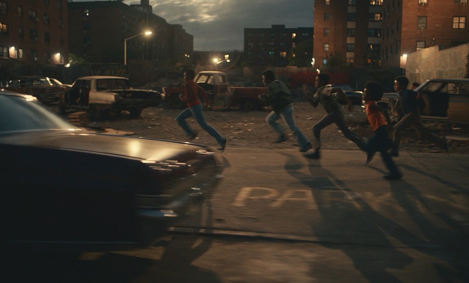A film still for Overstood showing teens running down the street at night